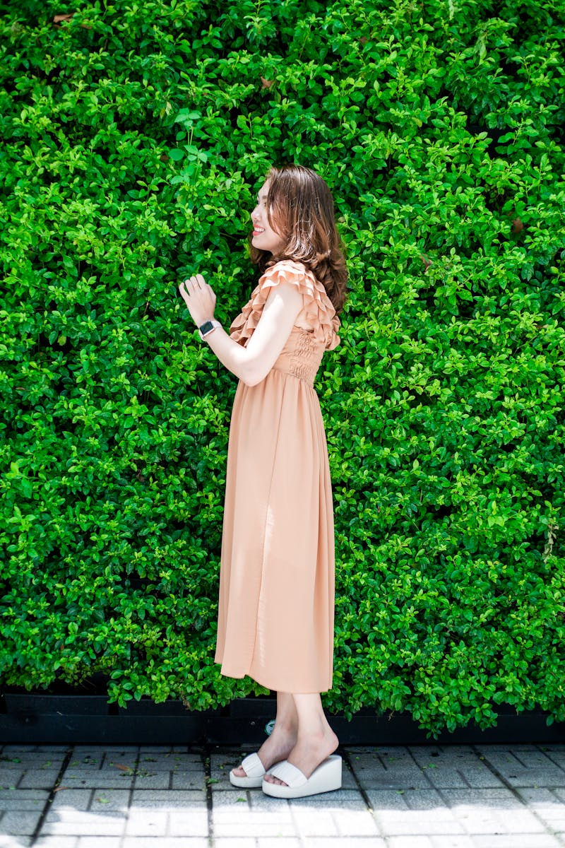 Woman Standing Near Green Plant