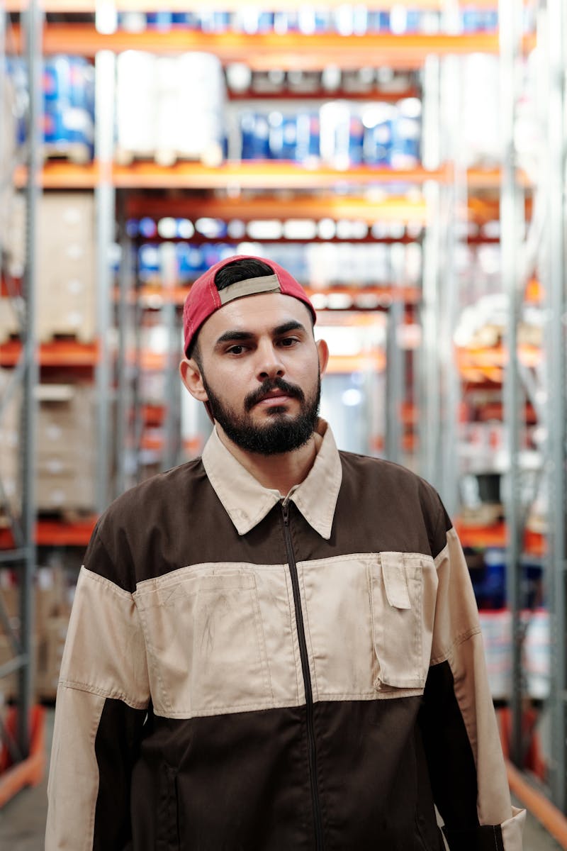 Man in Brown Button Up Shirt Wearing Red and Black Cap