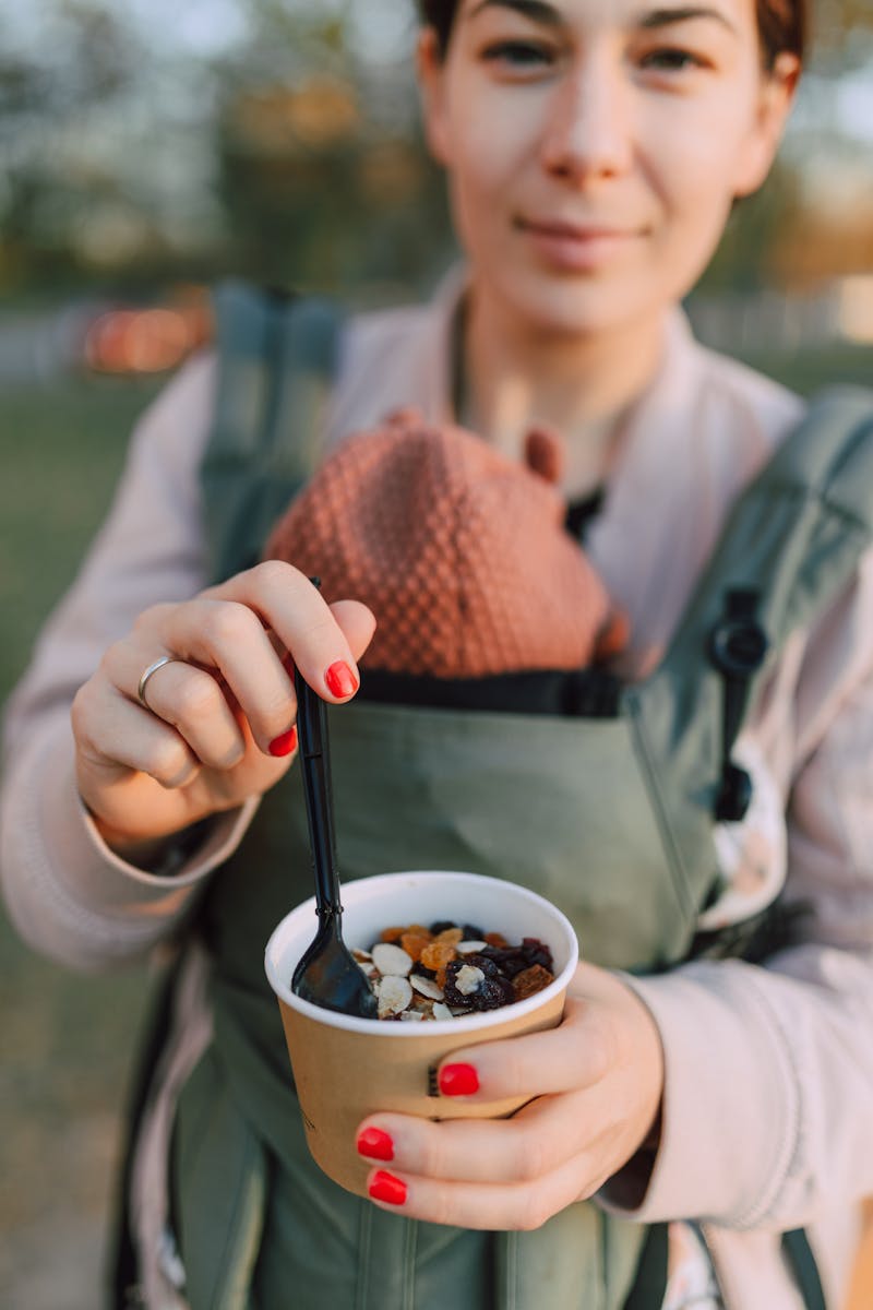 Woman holding a Disposable Cup filled with Oatmeal