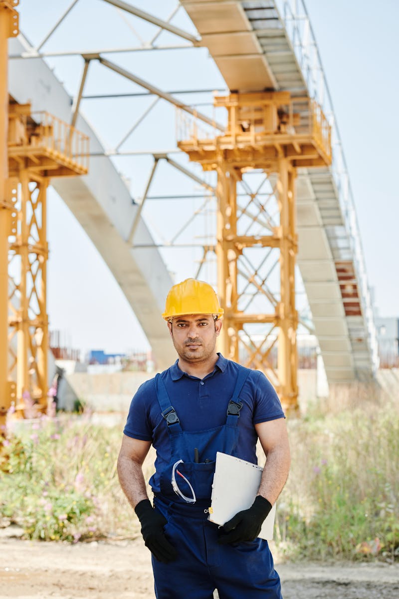 Man in the Construction Site Holding a Clipboard