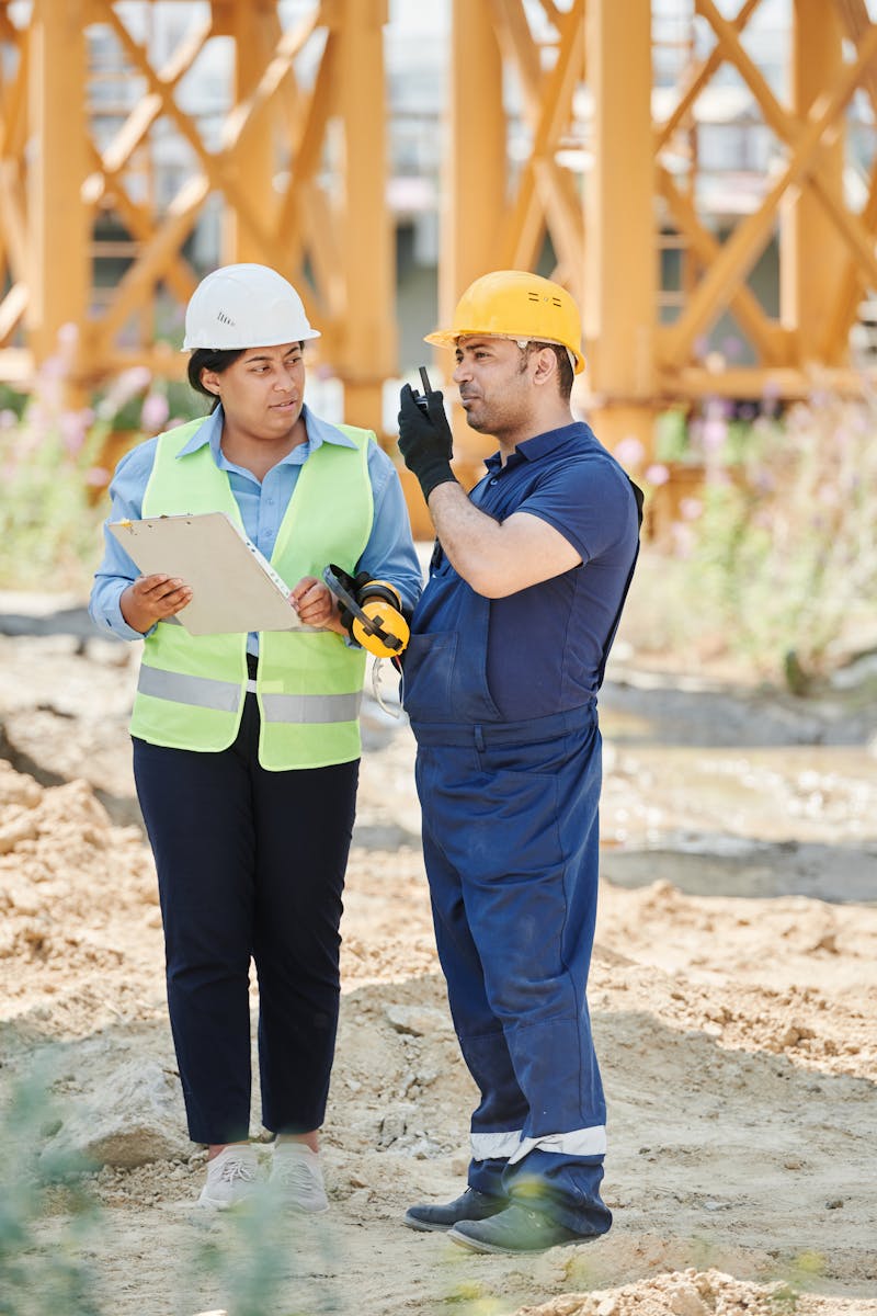 Man and Woman Working in a Construction Site