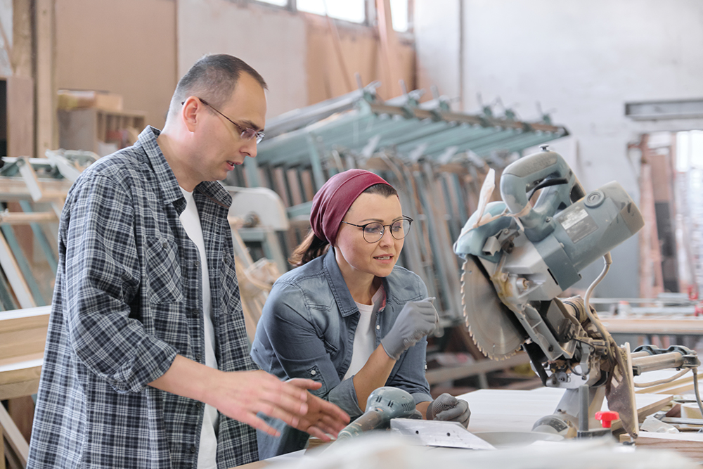 Industrial portrait of working men and women, people talking at work, furniture joinery production.
